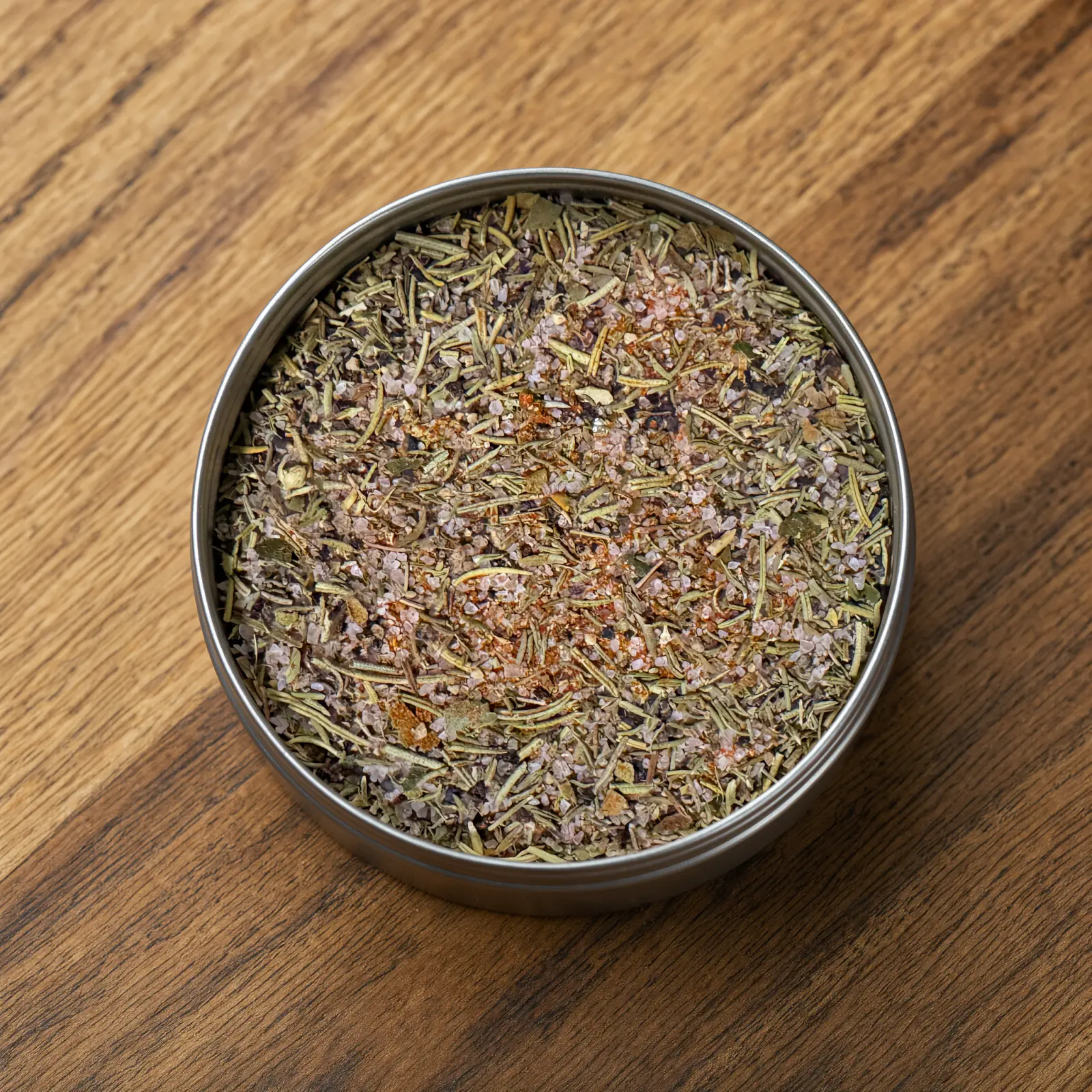 Moonshine BBQ Pollo Rub blend in an open tin, showing the texture
